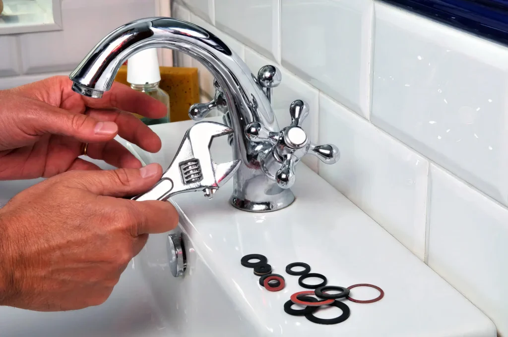 Plumber performing maintenance on a bathroom faucet in Fort Myers