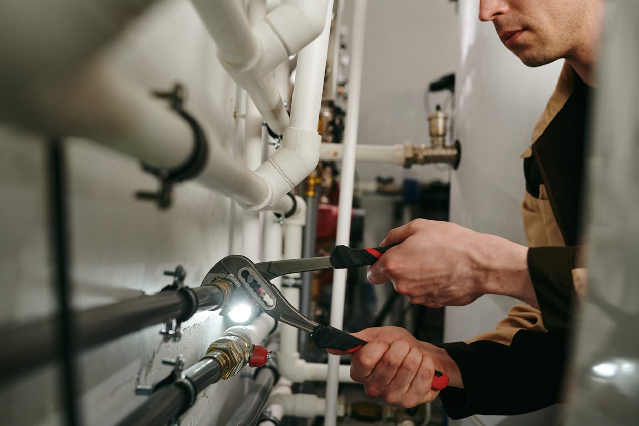 Plumbers maintaining commercial plumbing pipes in Fort Myers