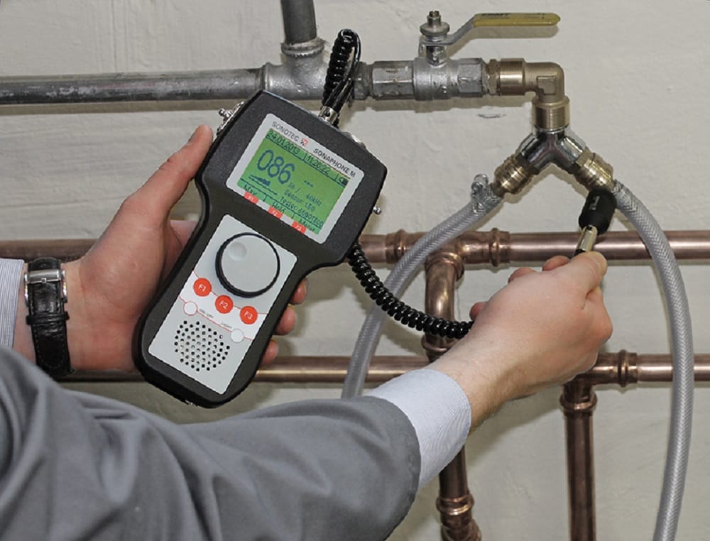 Plumber testing pipes with electronic leak detection equipment in Fort Myers