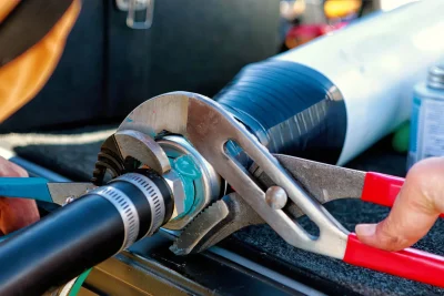 Technician tightening an industrial pipe connection in Fort Myers