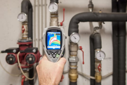 Plumber using a thermal imaging camera to inspect pipes in Fort Myers