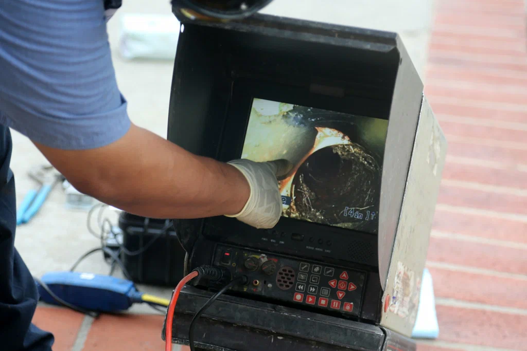 Technician viewing a drain inspection camera in Fort Myers