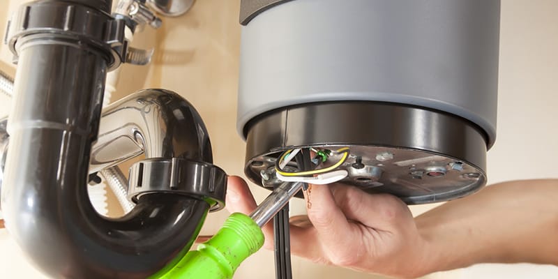 Technician repairing the heating element of a water heater in Fort Myers