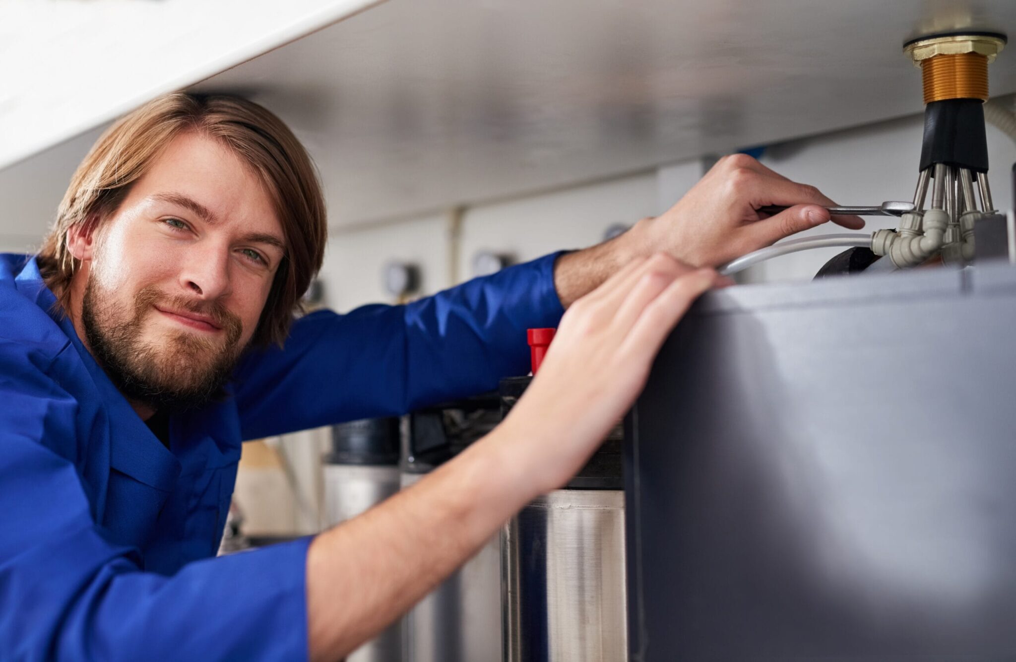 Technician servicing a residential water heater tank in Fort Myers