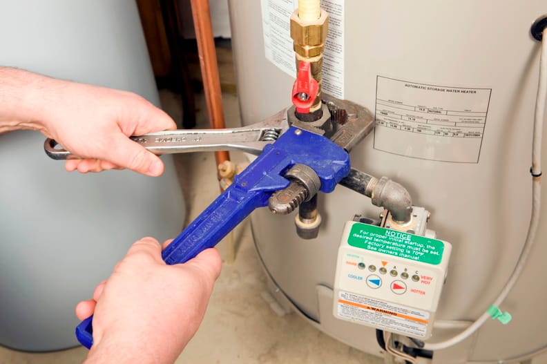Plumber repairing a water heater valve in Fort Myers
